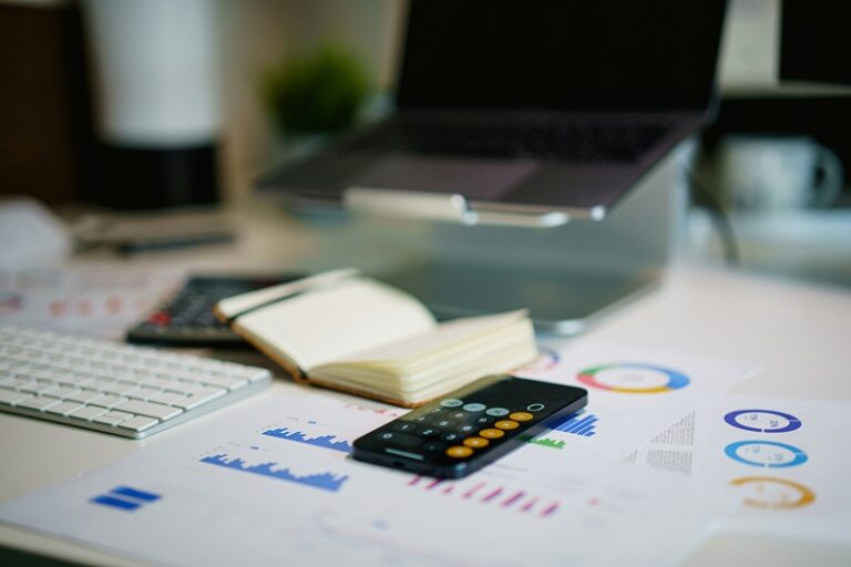 Property asset manager reviewing facility capital expenditure planning documents on a computer.