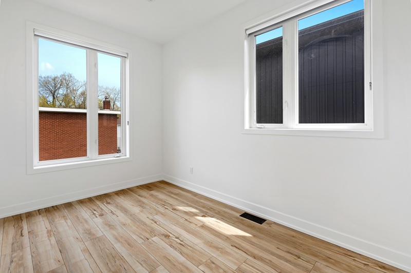 Empty residential hallway with natural light, representing a vacant home monitored by wireless sensors
