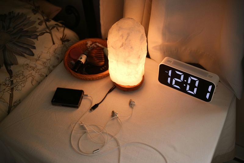 Smartphone on a nightstand displaying a missed middle-of-the-night emergency alert email.