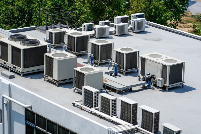 Wireless temperature sensor mounted near a commercial rooftop HVAC unit