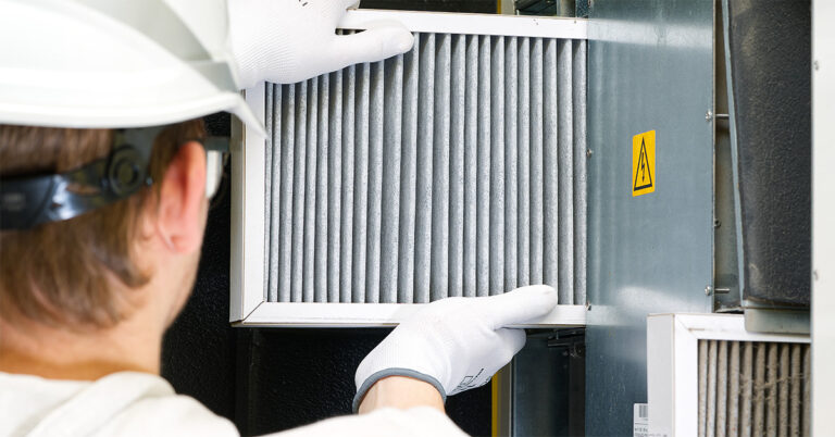 Facility technician performing a scheduled preventative maintenance check on HVAC equipment before any failure has occurred.